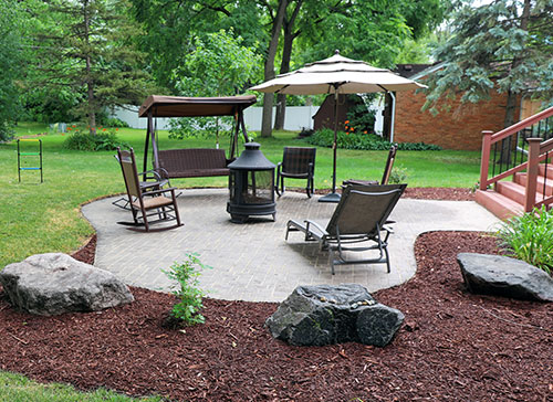 Beautiful hardscaped patio with fire pit, showcasing Foran Lawn & Yard's outdoor design expertise in Devon, PA.